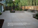 Light Sand Wash Finish Concrete with Unknown Integral  Color 42” Squares. 18“ Seatwall with Stucco Walls to Match House & a Pre-Cast Bull Nosed Concrete Cap to Match Patio Color - 14” Wide.
