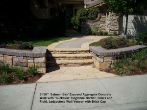 16” ‘Salmon Bay’ Exposed Aggregate Concrete Walk with ‘Buckskin’ Flagstone Border, Stairs and Field. Ledgestone Wall Veneer with Brick Cap 