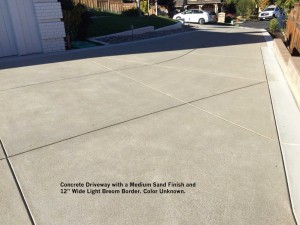 Concrete Driveway with a Medium Sand Finish and 12” Wide Light Broom Border. Color Unknown. 