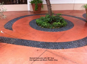 Stained-Concrete-with-48-Saw-Cut-Squares-and-Black-Pebble-Inlay       