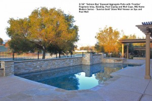 16” ‘Salmon Bay’ Exposed Aggregate Patio with ‘Frontier’ Flagstone Inlay, Banding, Pool Coping and Wall Caps. MG Home Modern Series - ‘Sunrise Gold’ Stone Wall Veneer on Spa and Pool Wall 2