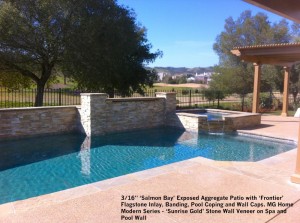 16” ‘Salmon Bay’ Exposed Aggregate Patio with ‘Frontier’ Flagstone Inlay, Banding, Pool Coping and Wall Caps. MG Home Modern Series - ‘Sunrise Gold’ Stone Wall Veneer on Spa and Pool Walls