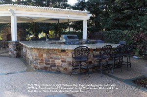 75% ‘Noiyo Pebble’ & 25% ‘Salmon Bay’ Exposed Aggregate Patio with 8” Wide Bluestone band. ‘ Kennesaw’ Ledge Thin Veneer Walls and Arbor  Post Bases. Satin Finish .Granite Counter Top
